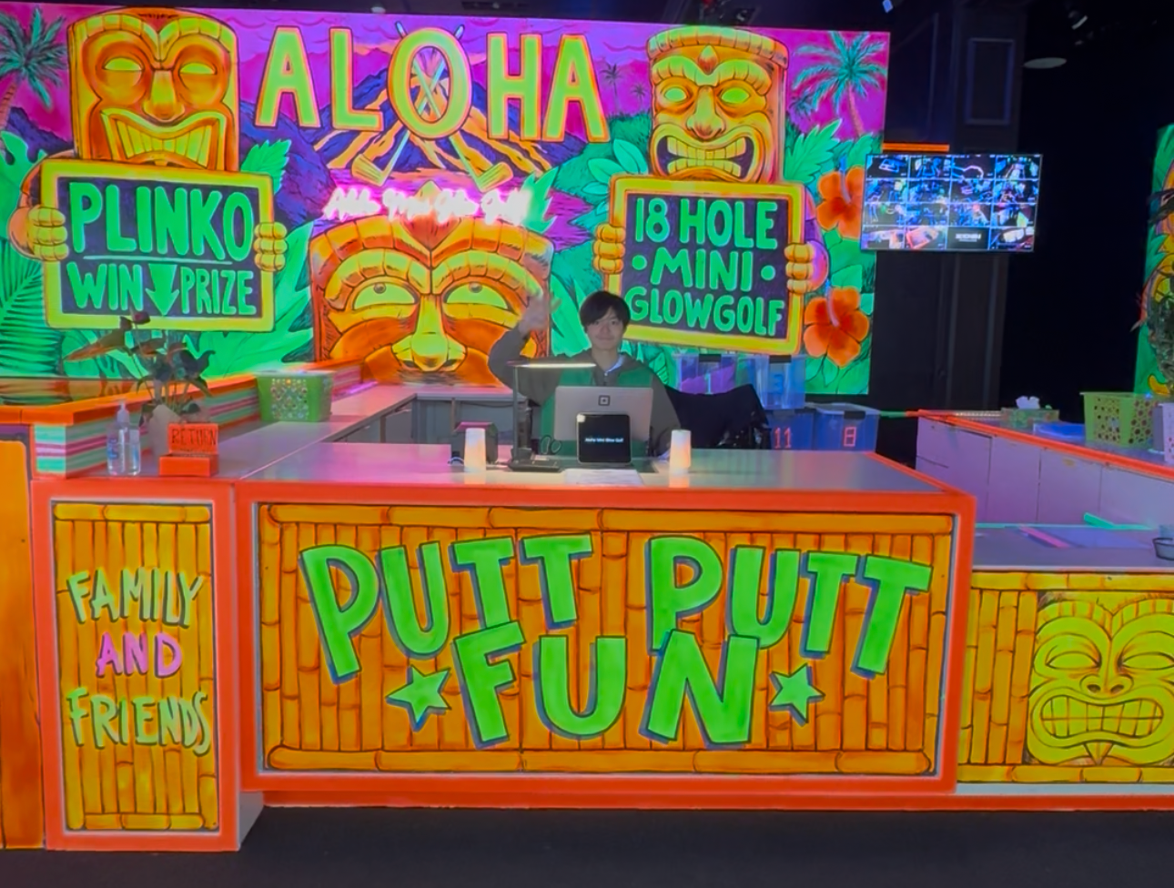 Aloha Mini Glow Golf front counter with tiki murals and a Putt Putt Fun sign